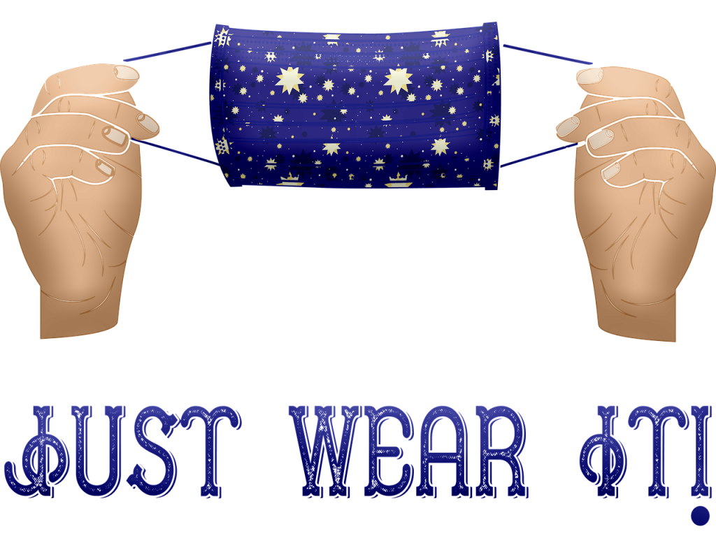 Cartoon image of hands holding a face mask. Text "Just Wear It!"