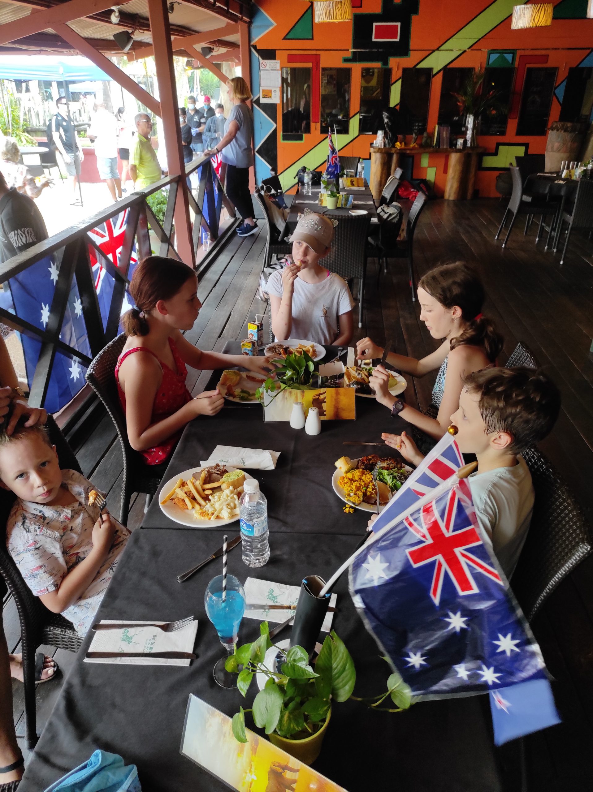 Children eating lunch surrounded by Australia and New Zealand flags